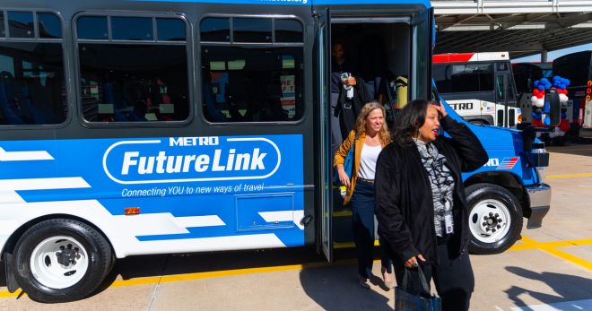 Two women exit from the the FutureLink shuttle.