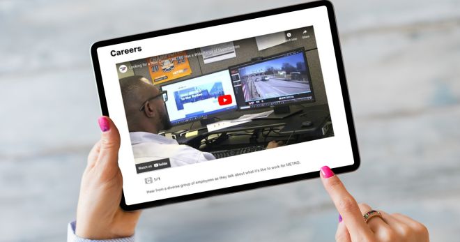 Woman's hands holding an ipad with METRO's careers page.