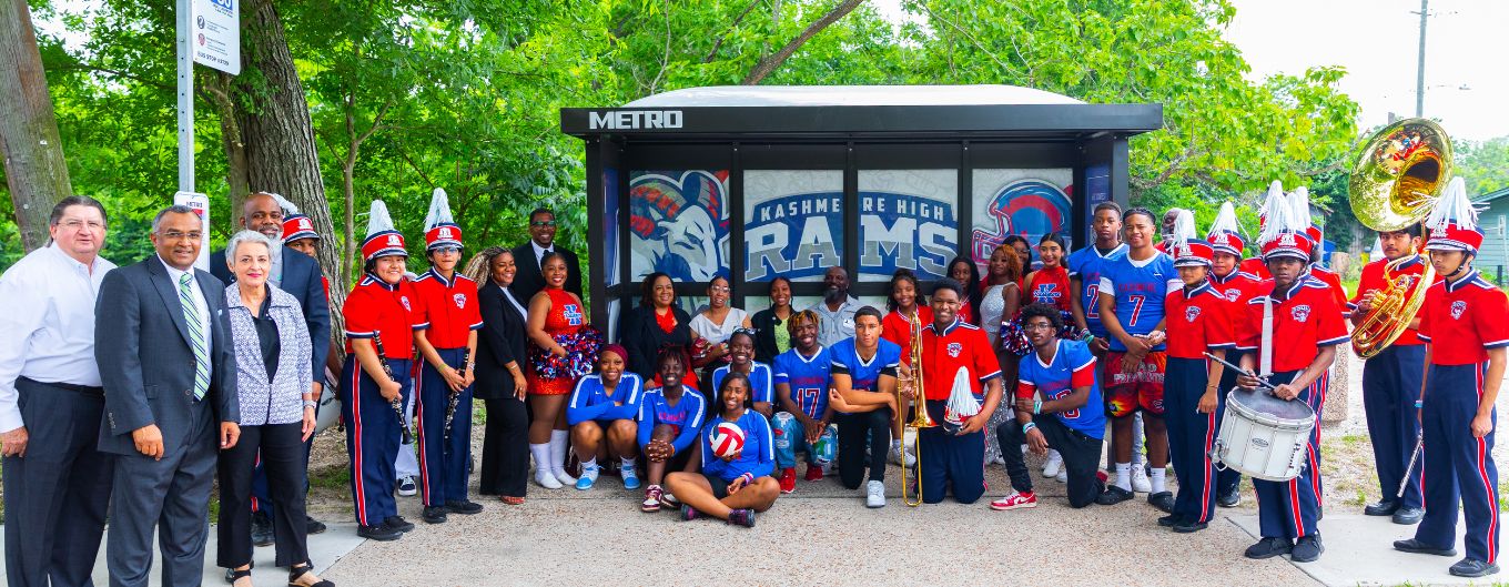 METRO Board Members, staff and HISD representatives take a photo in front of a new bus shelter designed by a Kashmere High School student.