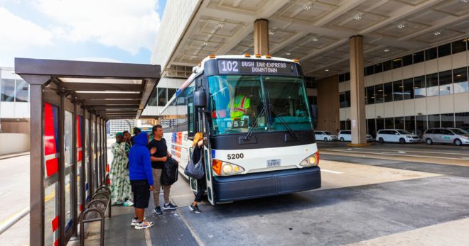 METRO bus arrives at IAH Terminal C to pick up travelers.