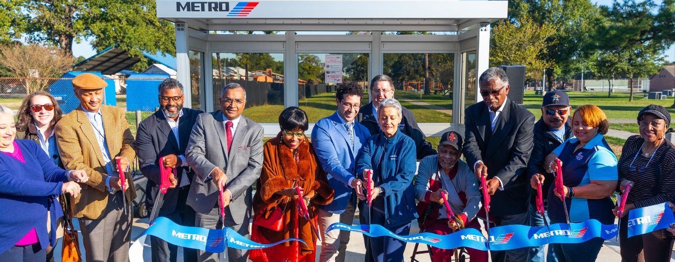 METRO Chair and Board Members, along with community members, cut ribbon on new METRO bus shelter.