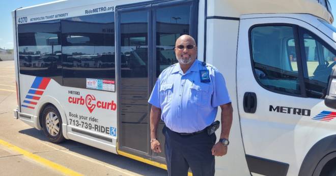 Operator Price stands in front of METRO curb2curb bus.