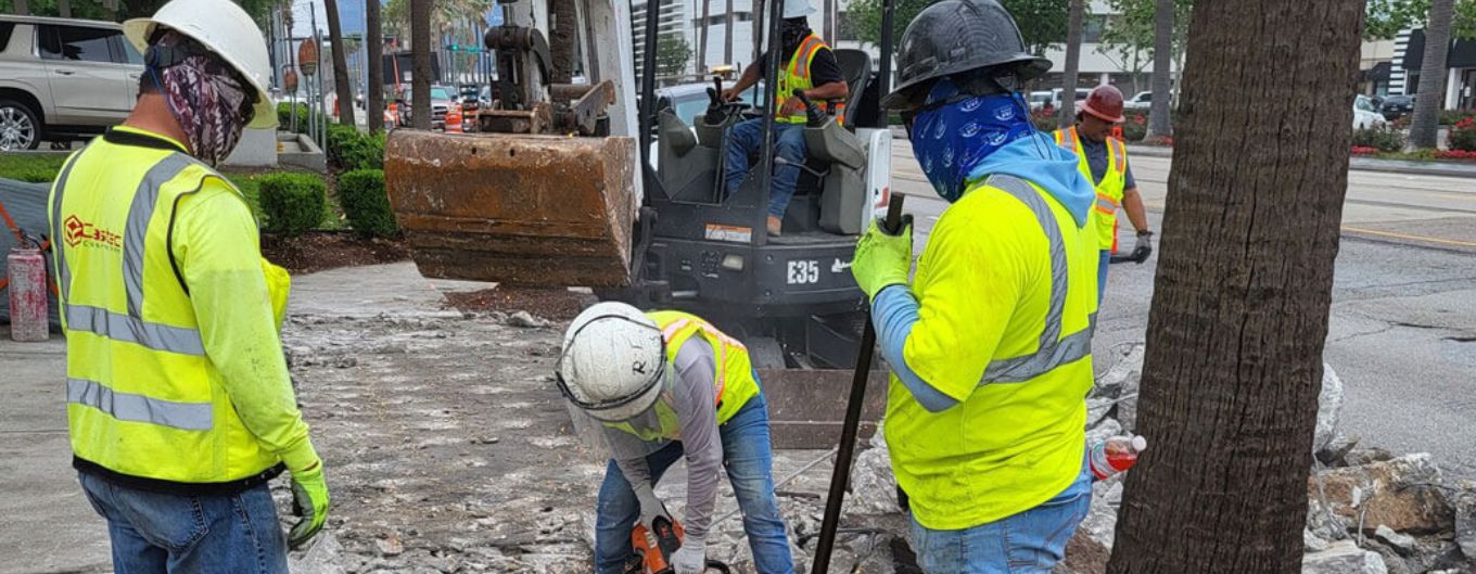 Workers break up old concrete in preparation for a new bus pad and sidewalk along Westheimer.
