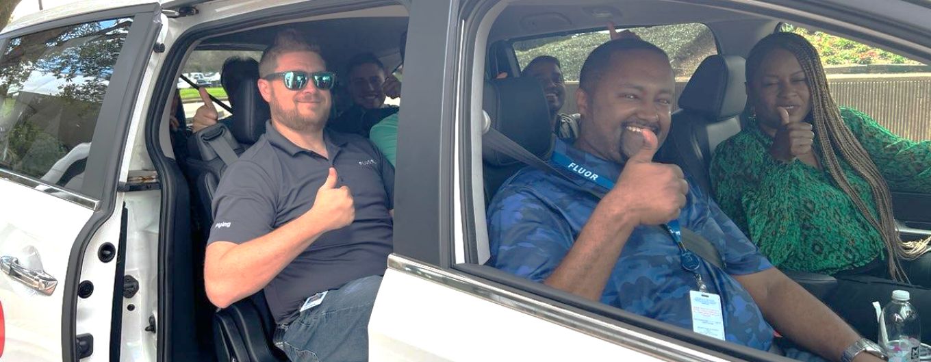 Fluor employees in a METRO Vanpool vehcile give a thumbs up.