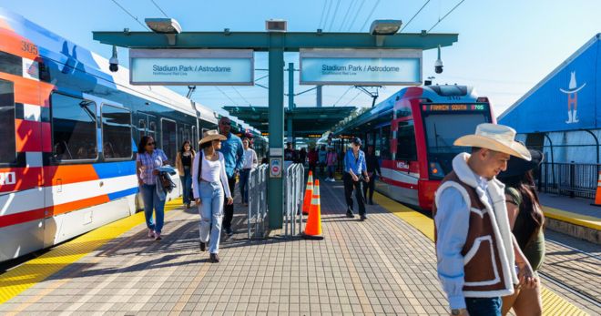 Riders exit a METRORail train to the Houston Livestock Show & Rodeo.