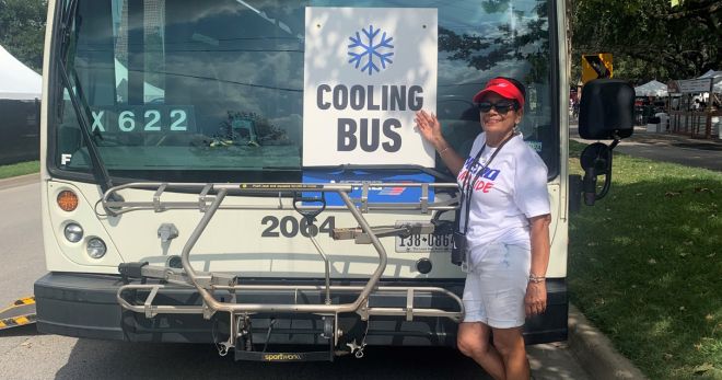 Photo os a METRO employee standing in front of a bus with a sign stating,