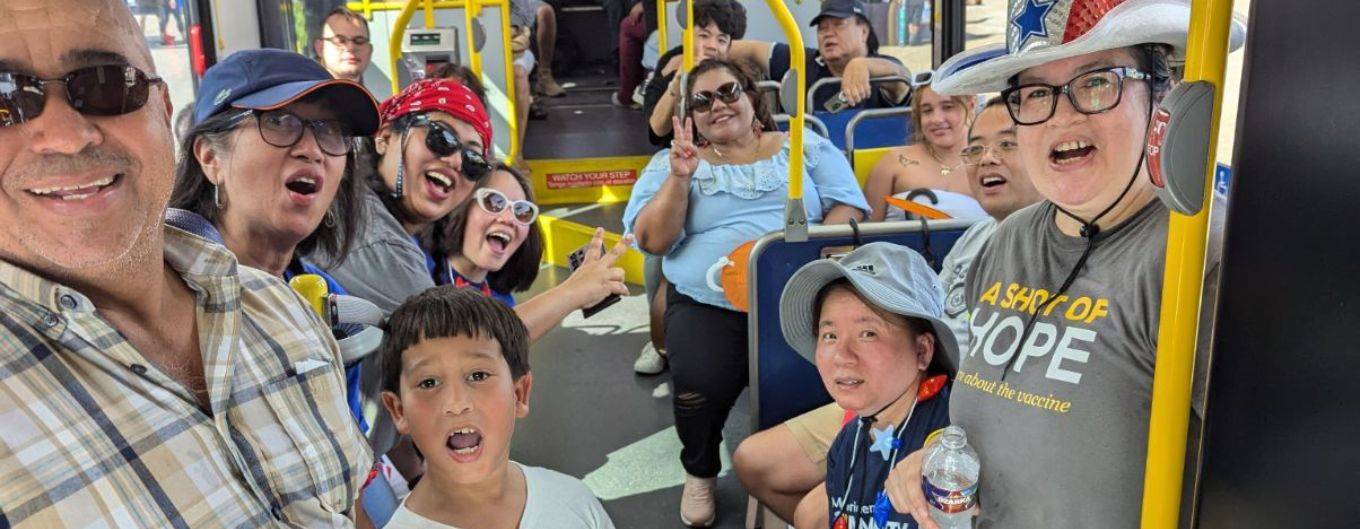 Smiling families and residents cool off on a METRO bus on July 4