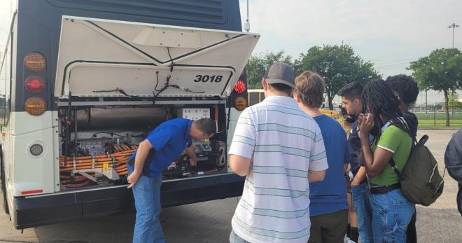 Students view the mechanical componenets of METRO's electric bus.