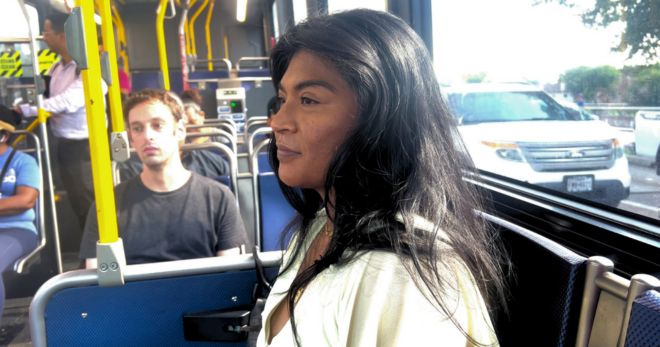 Nadia sits in a bus.