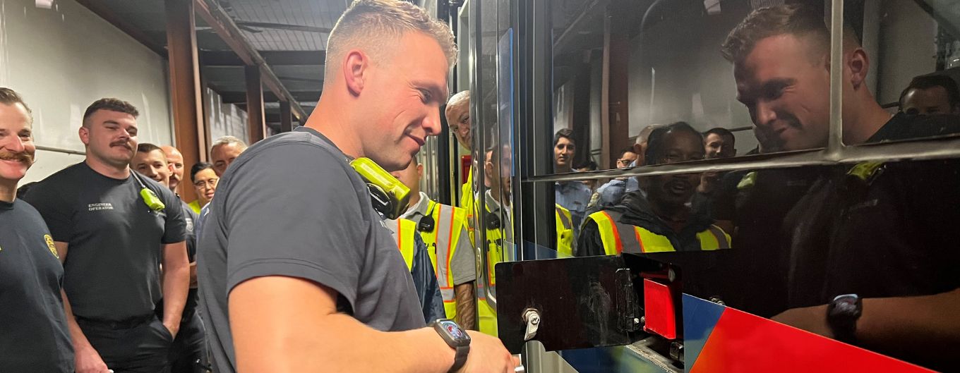 Firefighter stands at a METRO train.