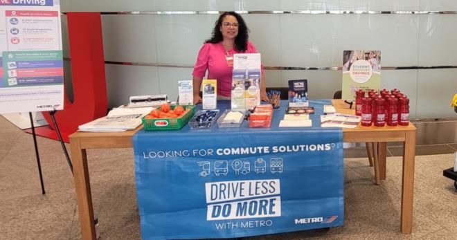 Jeanette De Los Santos stands at METRO's Commute Solutions booth.