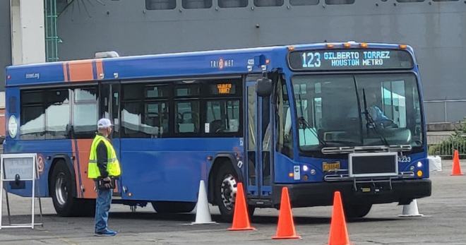 A blue bus driven by METRO operator Gilberto Torres navigates a driving course.