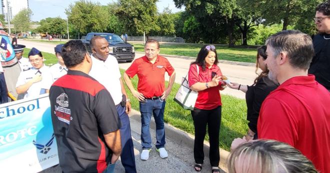 Art Murillo and METRO volunteers visit with parade-goers.