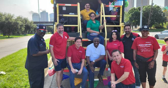 METRO volunteers pose for a photo in the back of METRO's all-weather utility vehicle.