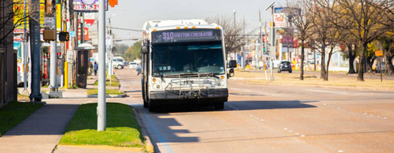 310 Gulfton Circulator local bus on the road.