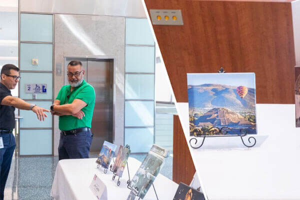 METRO employee, John Castillo standing next to his art work talking with another co-worker.