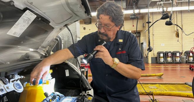 Diesel Mechanic Balderas works on an engine.