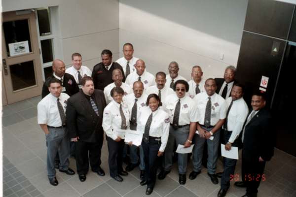 Art Belton (in the back wearing a black cardigan) poses with the first group of METRORail operators in 2004.