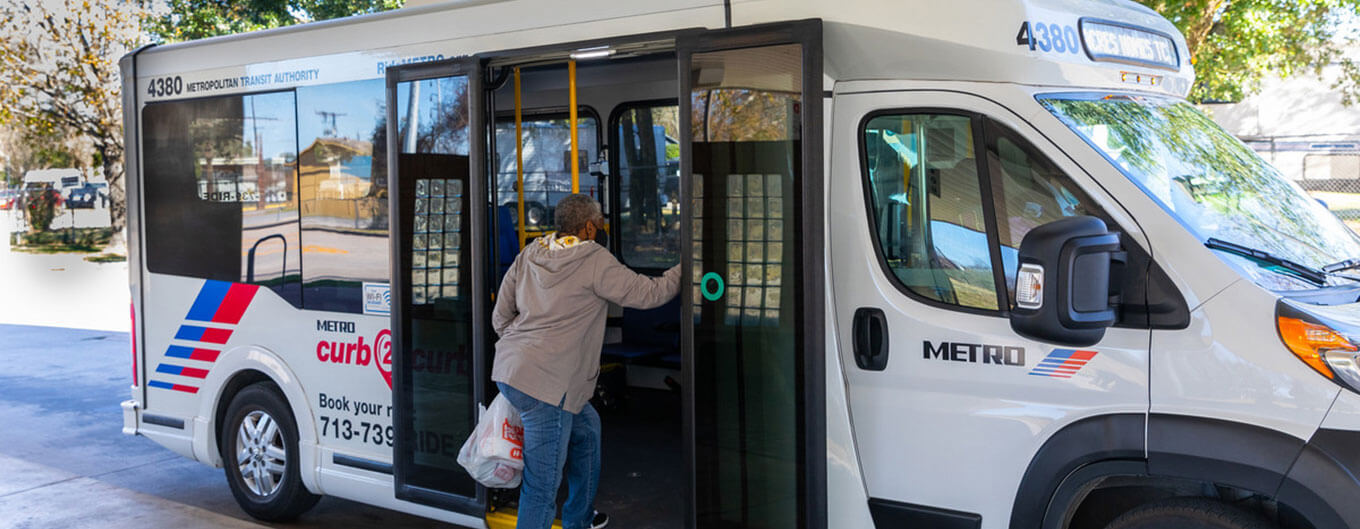 Rider boarding METRO curb2curb shuttle bus.