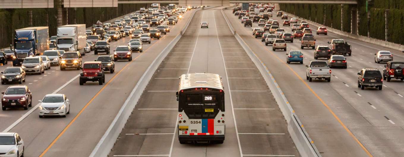 A METRO bus drives through the HOV lane to avoid traffic.