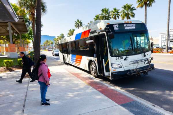 A passenger is about to board the 82 Westheimer bus.