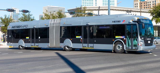 METRORapid Silver Line vehicle riding along Post Oak Boulevard in uptown Houston.