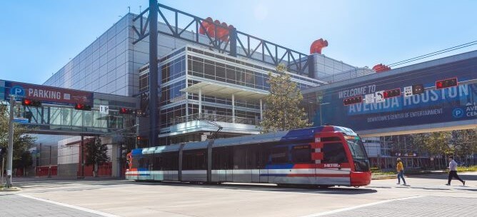 METRORail traveling through downtown passing the George R. Brown Convention Center.