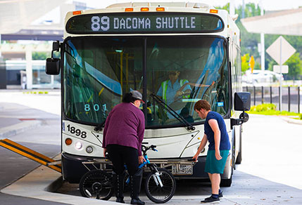 11485-passenger-putting-bike-on-bus Passengers adds bike to bus bike rack