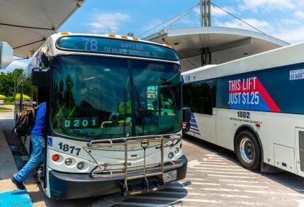 4645-Access-by-Transfer-429X292 Passenger transferring between two METRO buses at transit center.