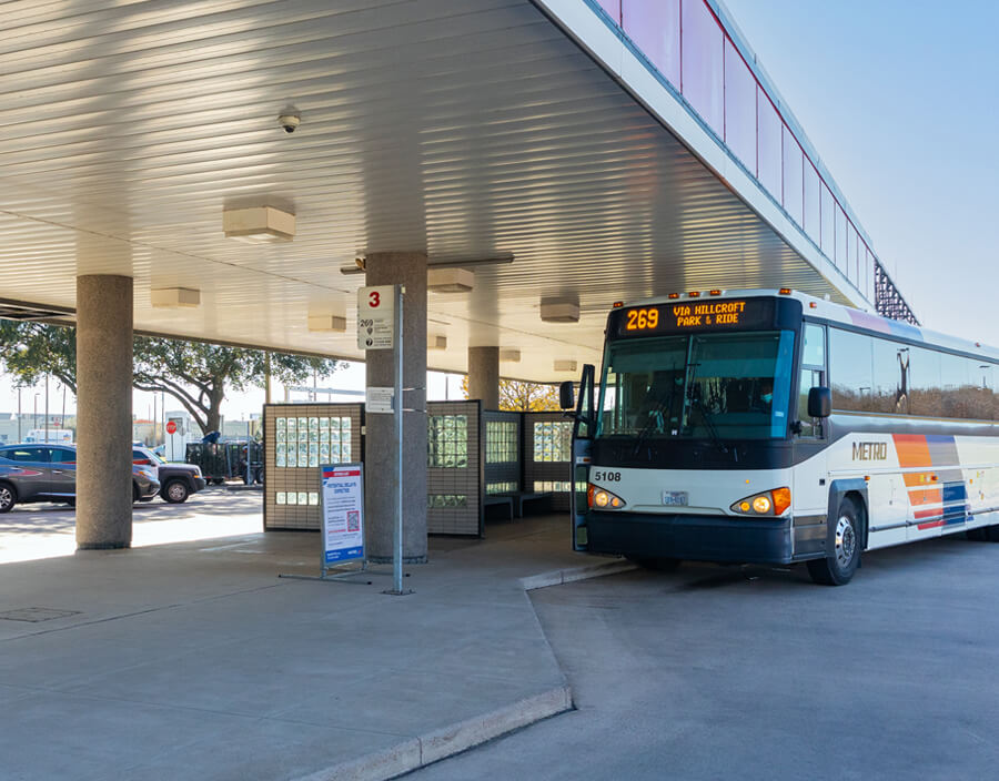 269 West Bellfort bus picking up riders at West Bellfort Park & Ride with cars parked nearby.
