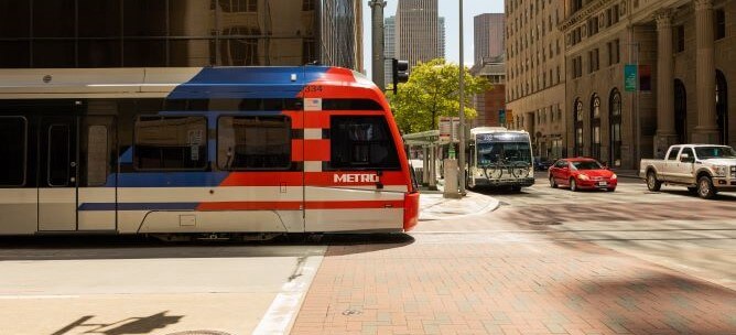 METRO local bus and METRORail at an intersection.