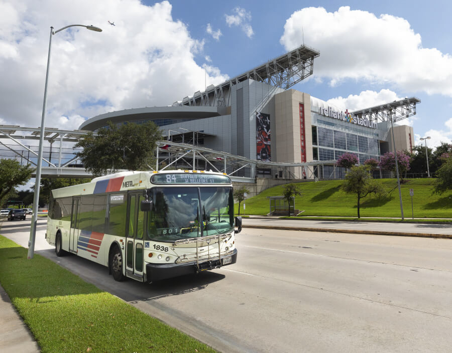 METRO local bus driving past Reliant Stadium on Kirby Drive.