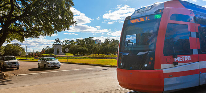 METRORail Red Line traveling northbound past Hermann Park.