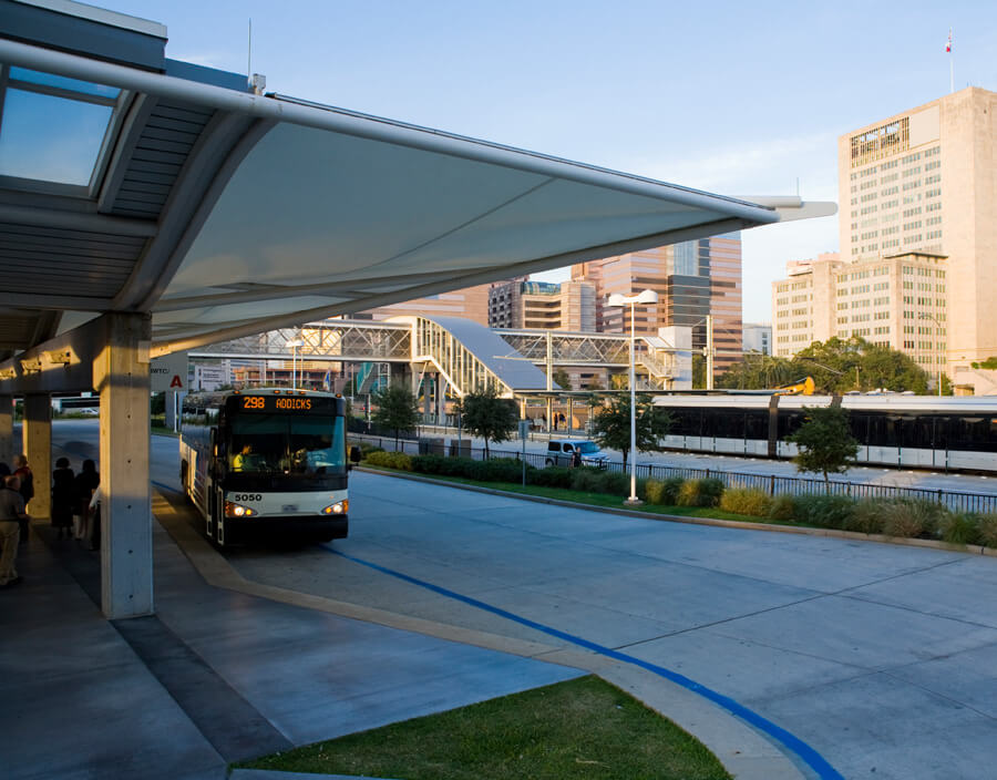 Park & Ride bus and METRORail Red Line train at the TMC Transit Center in Houston, Texas.