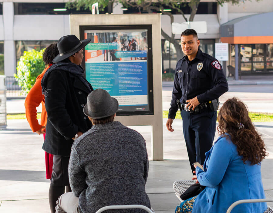 METRO Police Officer speaking with customers at a METRO facility.