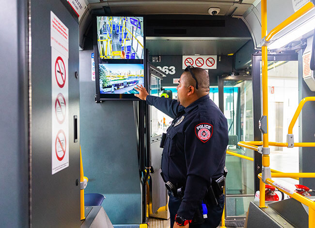 METRO police officer viewing an onboard security monitor.