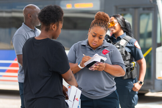 C.A.R.E. Unit out in the field taking down person's information to offer help.