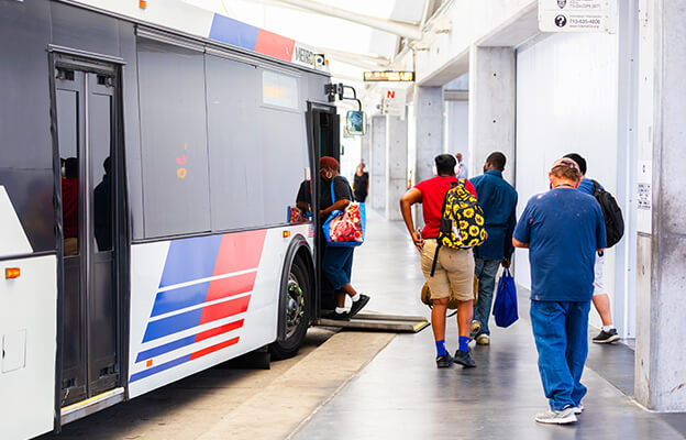 Riders boarding a METRO local bus at the Texas Medical Center transit center