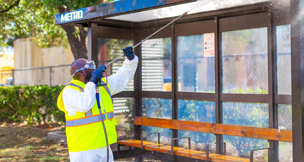 The inside of a bus shelter that is being powerwashed.