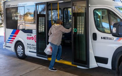 Customer boarding METRO curb2curb low-floor shuttle bus.