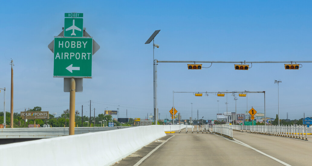 Signage pointing toward Hobby Airport / Monroe Road exit from the I-45 South express lane.