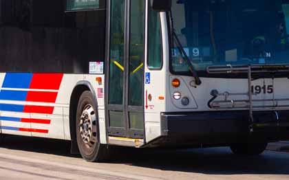Local bus three quarter front view on the road.