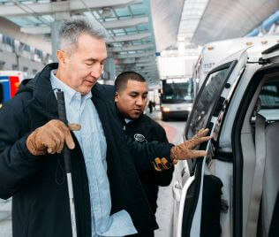 1089-paratransit-316X268 Attendant assists visually impaired customer into METROLift minivan vehicle
