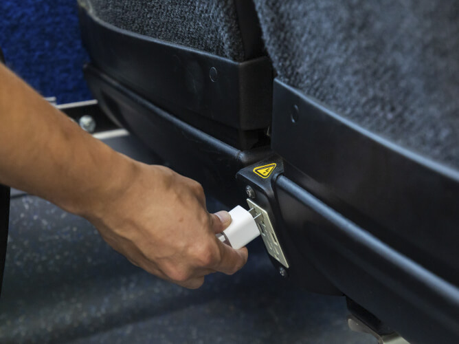 USB electrical outlets found in front of each row of seats on a Park & Ride bus.