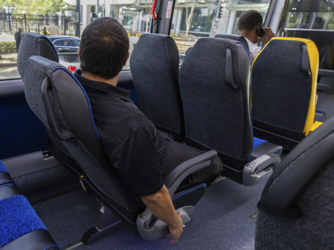 METRO customer reclining in his seat on a Park & Ride bus.