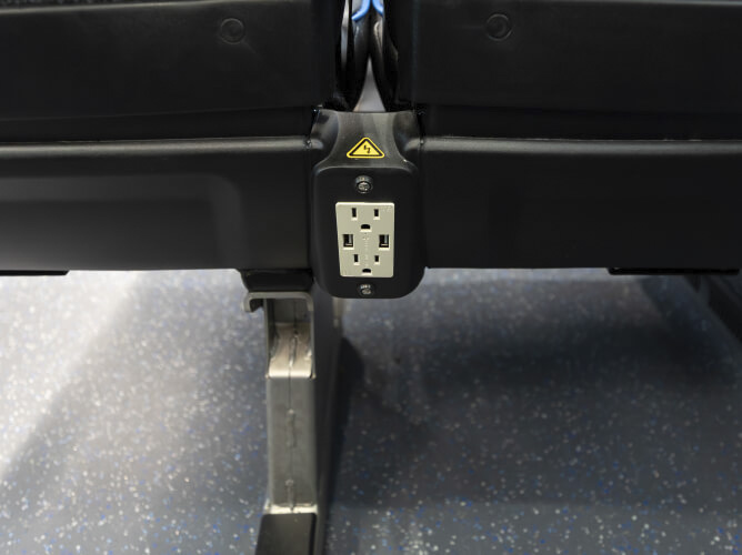 Power outlet and USB ports in front of seats on METRO Park & Ride buses.
