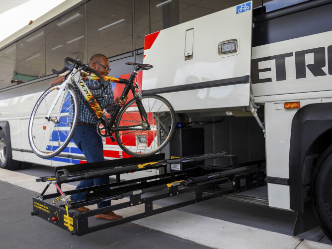 A bicycle stored in the storage compartment located on the outside the bus.