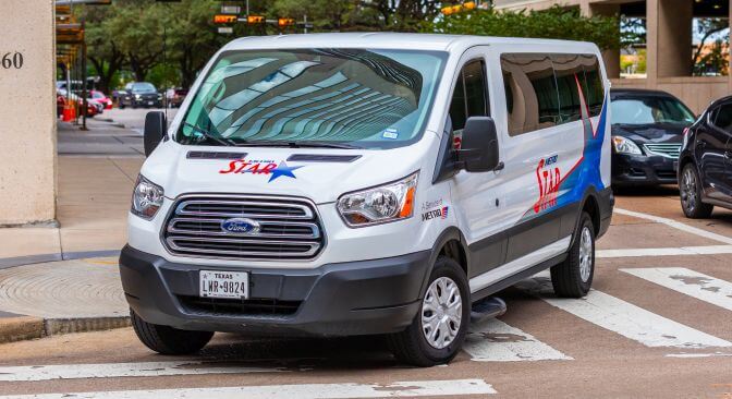 METRO Vanpool vehicle turning a corner on to Fannin Street in the Texas Medical Center.
