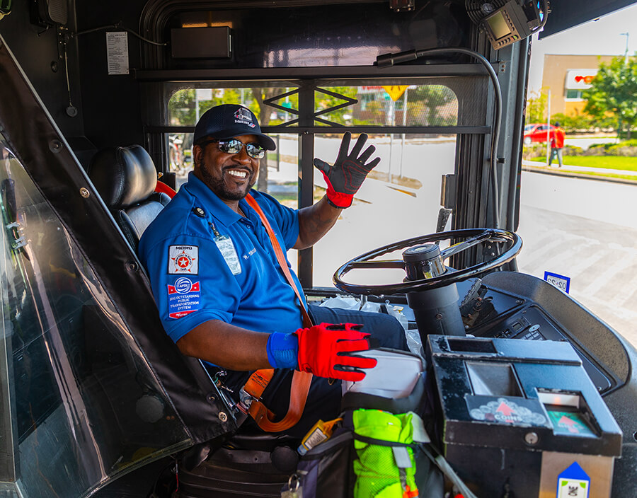 METRO bus operator smiling and waiving hello.