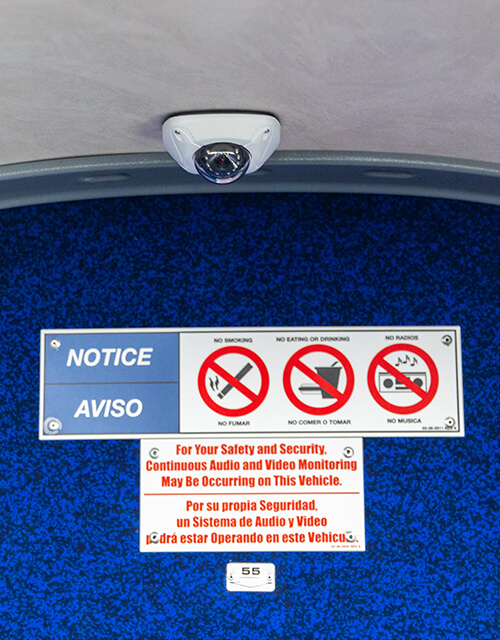 Signage onboard a Park & Ride bus with symbols indicating that no food, drinks or smoking is allowed.